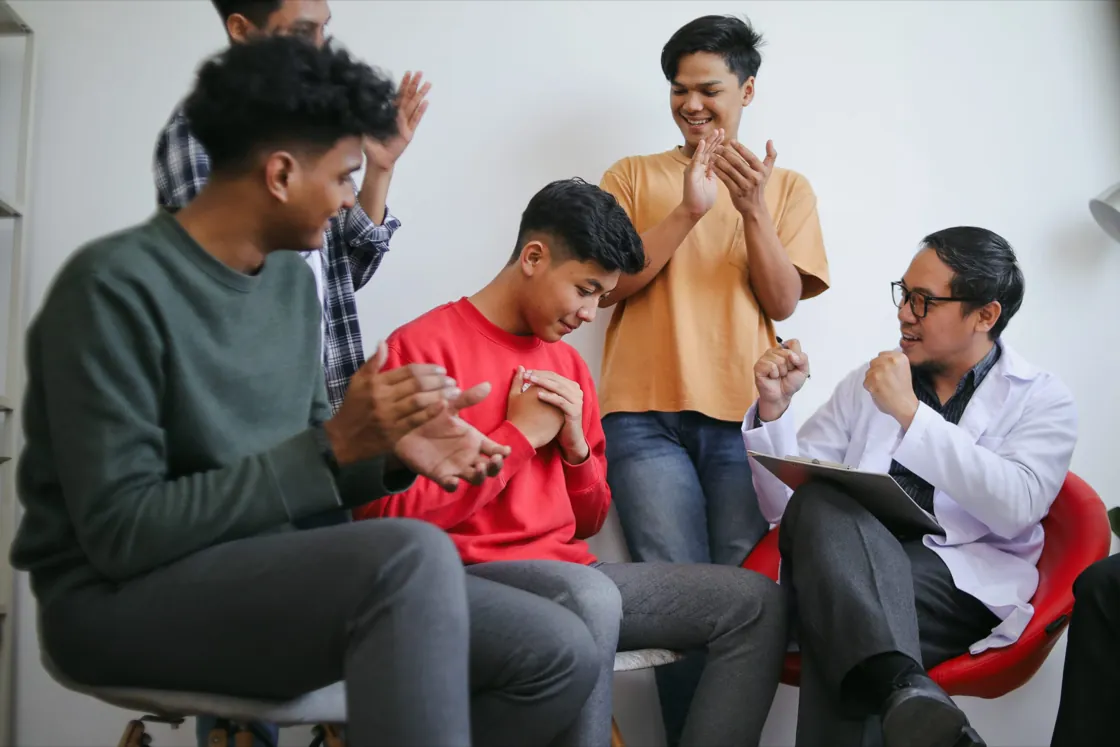 Teens talking openly during an adolescent group therapy session at Ethos Wellness