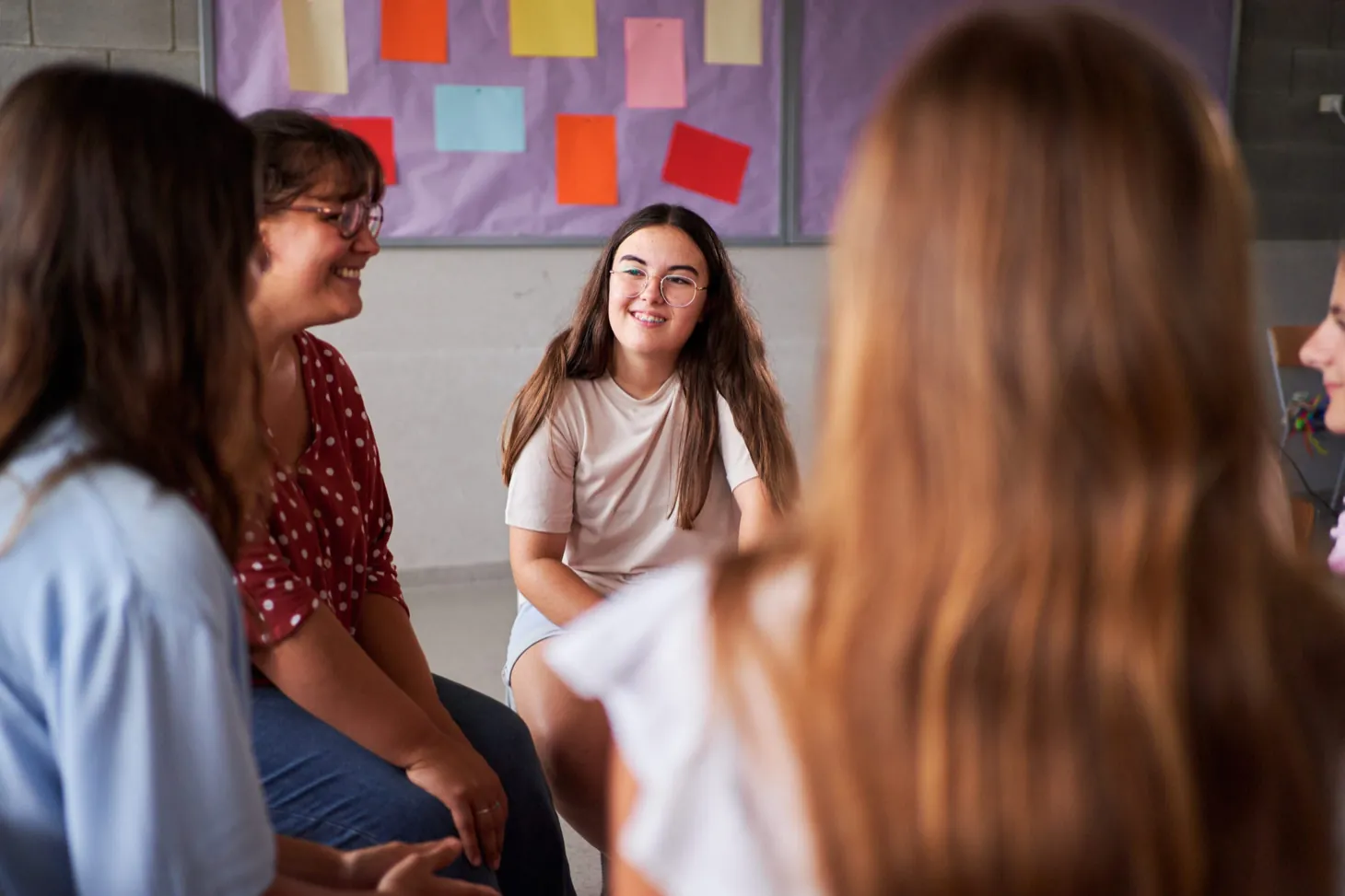 Teens in a supportive group therapy circle at Ethos Wellness
