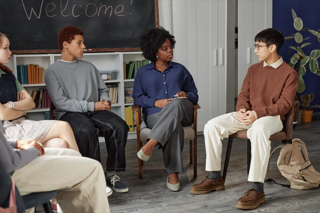 Clinician guiding a small, supportive teen group session at Ethos Wellness