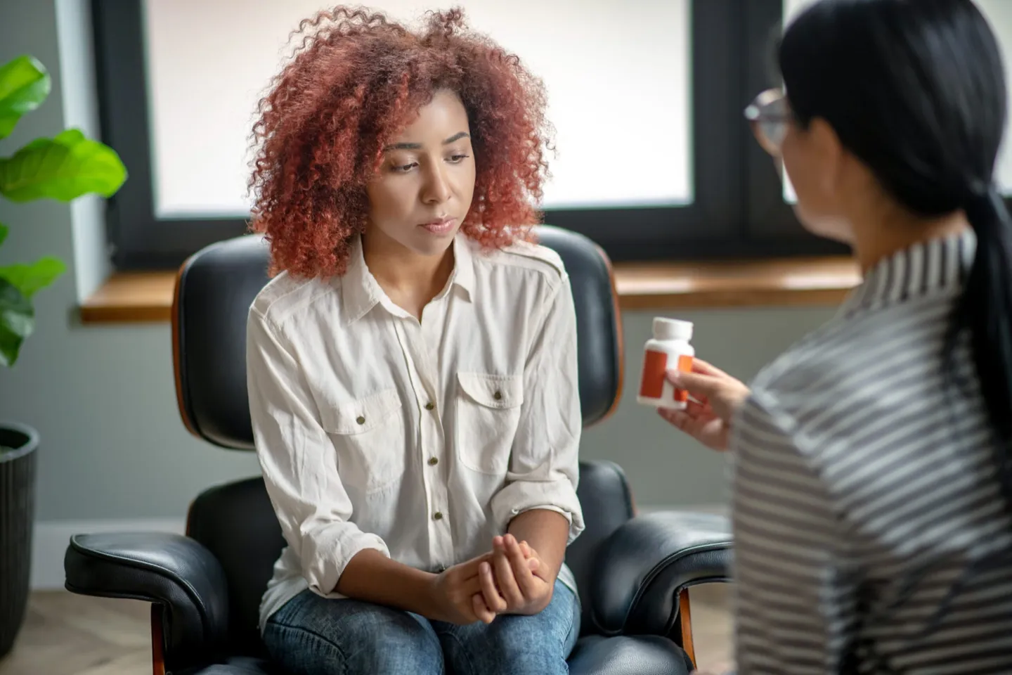 Psychiatrist taking notes during an adult psychiatry appointment at Ethos Wellness