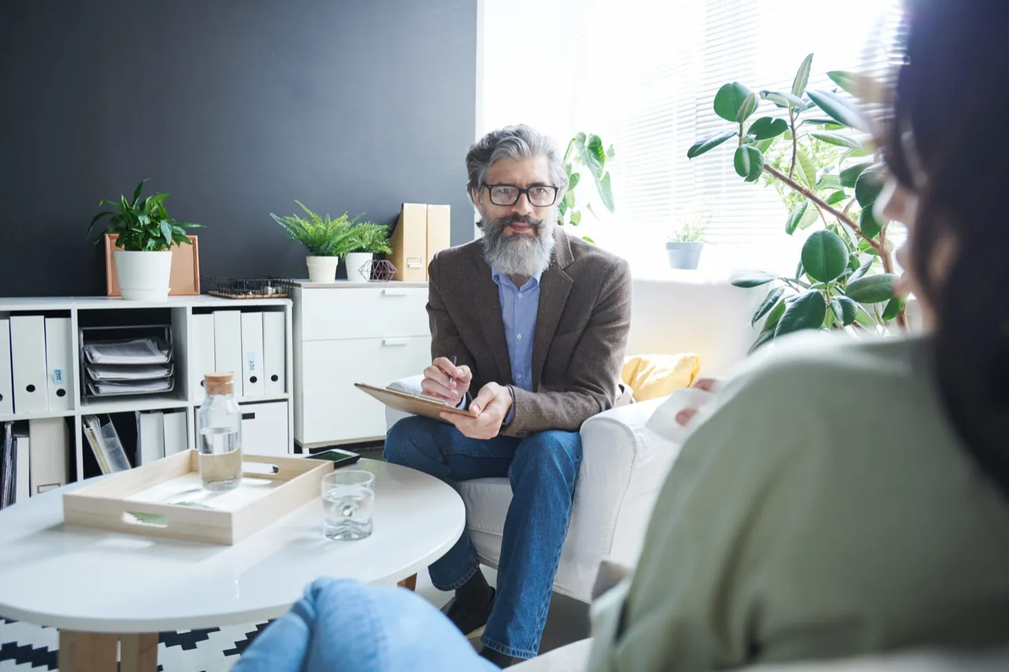 Adult in therapy session with a clinician at Ethos Wellness