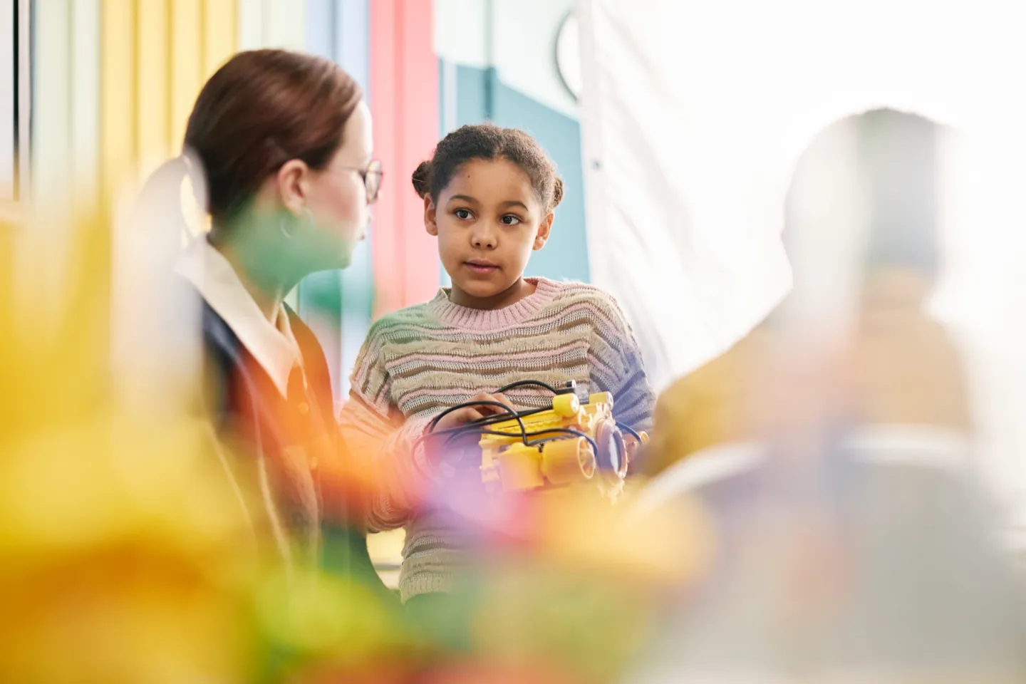 Child engaging in a creative therapeutic activity with an instructor at Ethos Wellness