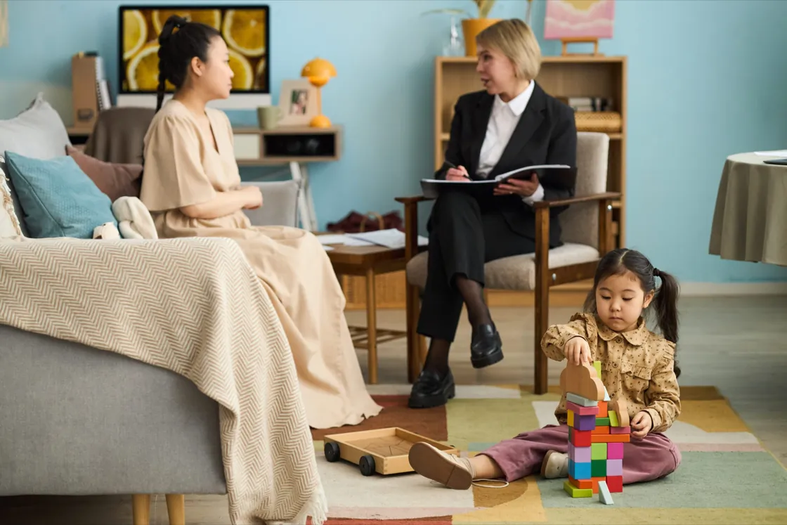 Family in a counseling session with a young child at Ethos Wellness