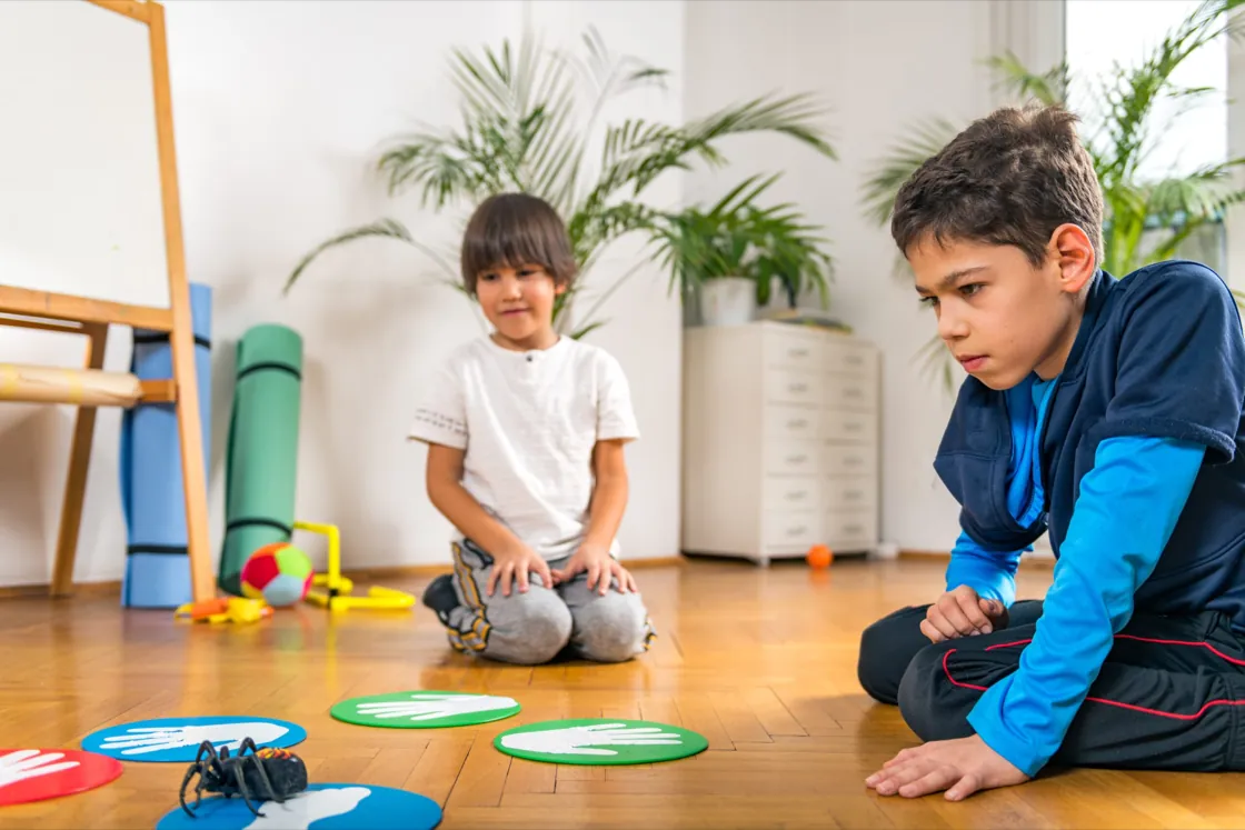 Child playing with sand tray figures during a play therapy session at Ethos Wellness
