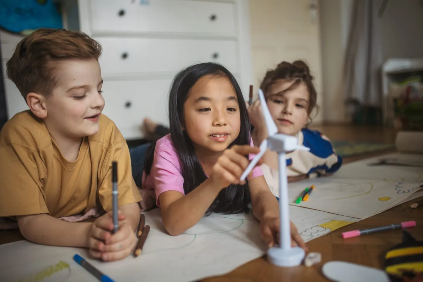 Child painting at a table with a therapist at Ethos Wellness