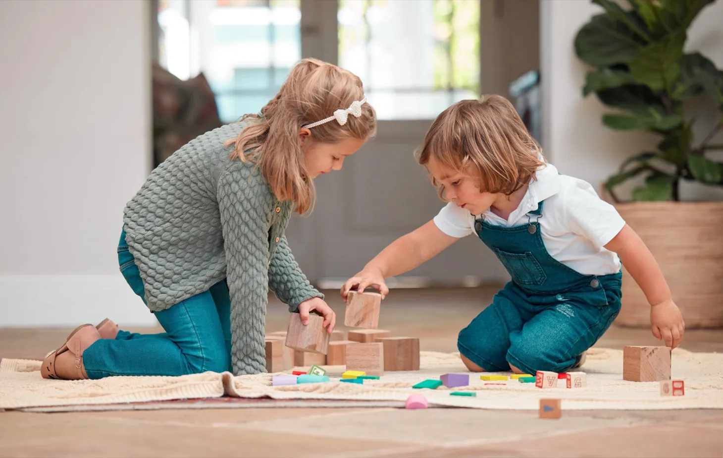 Child engaged in play-based therapy with toys and art at Ethos Wellness